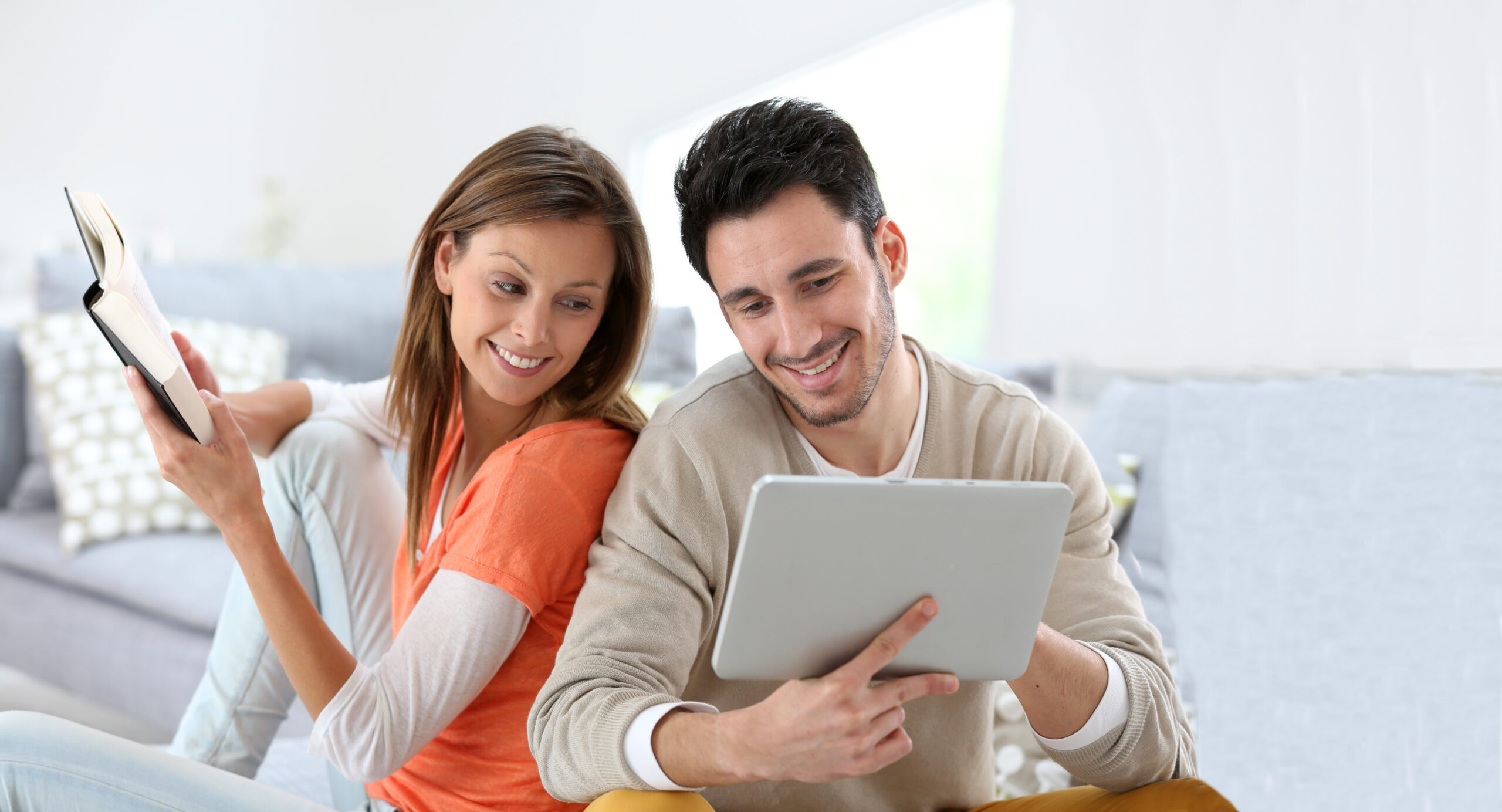 Couple relaxing at home sitting in sofa