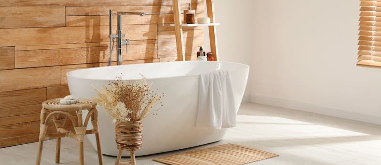 Bathroom interior with white tub and decor near wooden wall